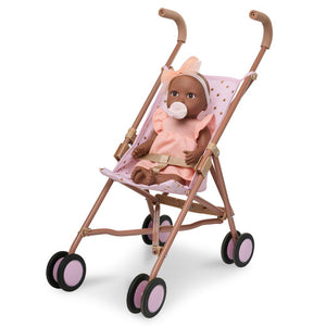 Babypuppe mit Schnuller – in einem orangefarbenen Kleid und mit einem Stirnband
