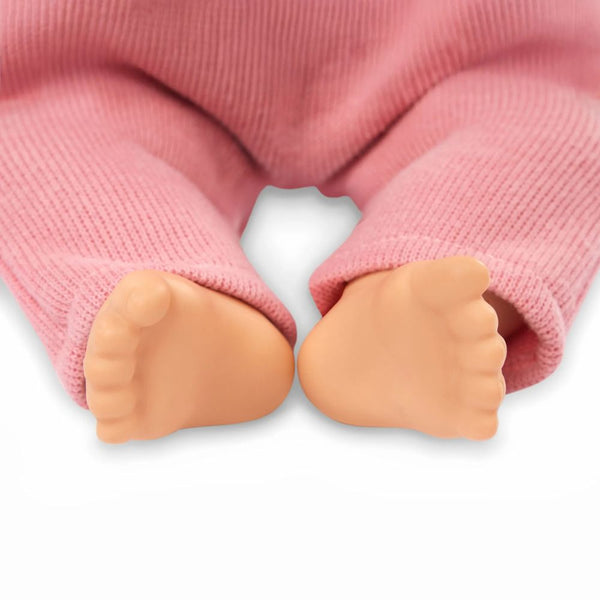 Baby-Puppe mit Schnuller, im Strampler und mit Stirnband