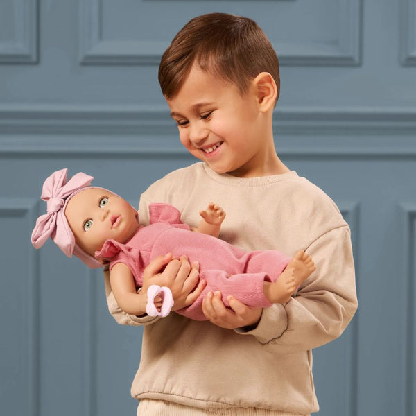 Baby-Puppe mit Schnuller, im Strampler und mit Stirnband