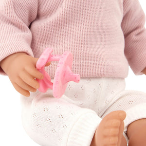 Babypuppe mit Haaren und Schnuller, in einem zweiteiligen Outfit