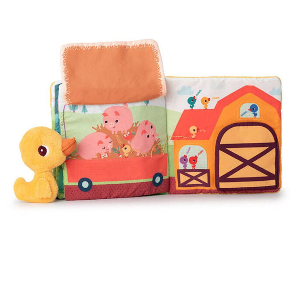 Stoffbuch-Seite mit Schweinchen, Traktor und Scheune, daneben Mini-Kuscheltier Ente