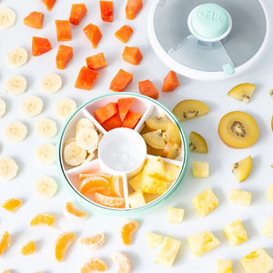 Gobe Snack Spinner Snackbehälter Mint Green mit verschiedenen Obststücken gefüllt