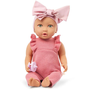 Baby-Puppe mit Schnuller, im Strampler und mit Stirnband