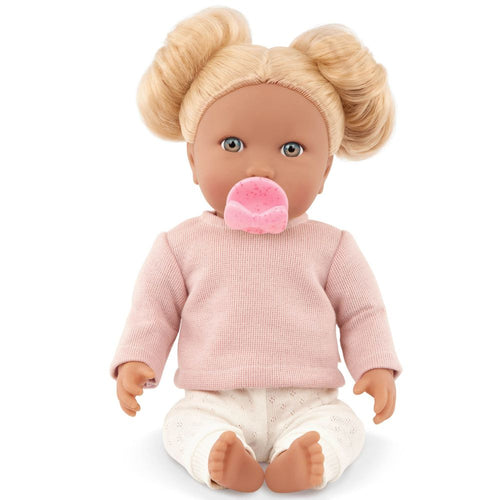 Babypuppe mit Haaren und Schnuller, in einem zweiteiligen Outfit