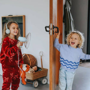 Kinder mit Soundverstärker für Kinder spielen in einem hellen Raum, Lächeln und Freude pur